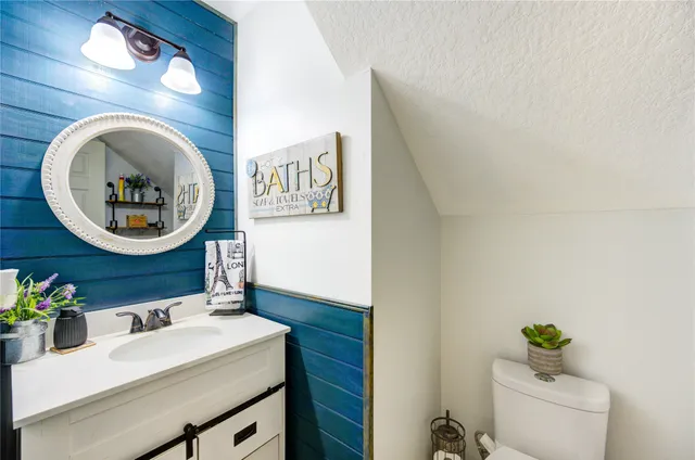 a bathroom with a sink mirror and vanity
