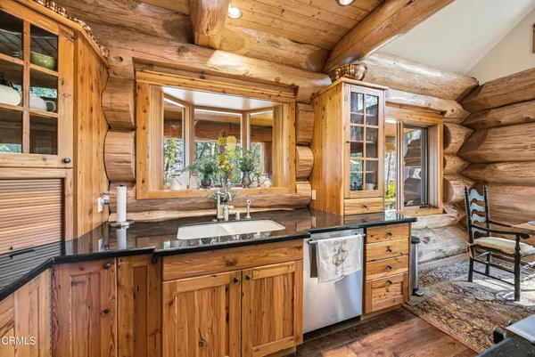 a bathroom with a granite countertop sink a mirror and shower