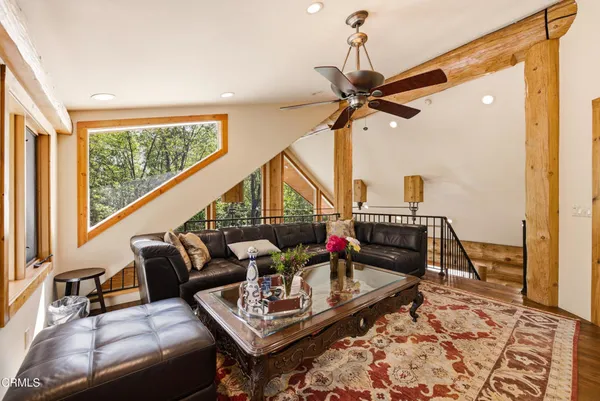 a living room with furniture a flat screen tv and a rug
