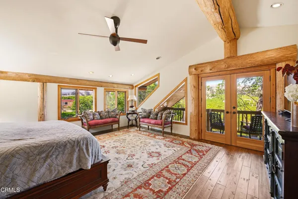 a view of balcony with chairs and wooden floor