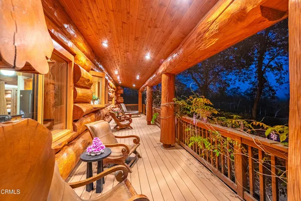 a view of a house with wooden floor and a fence