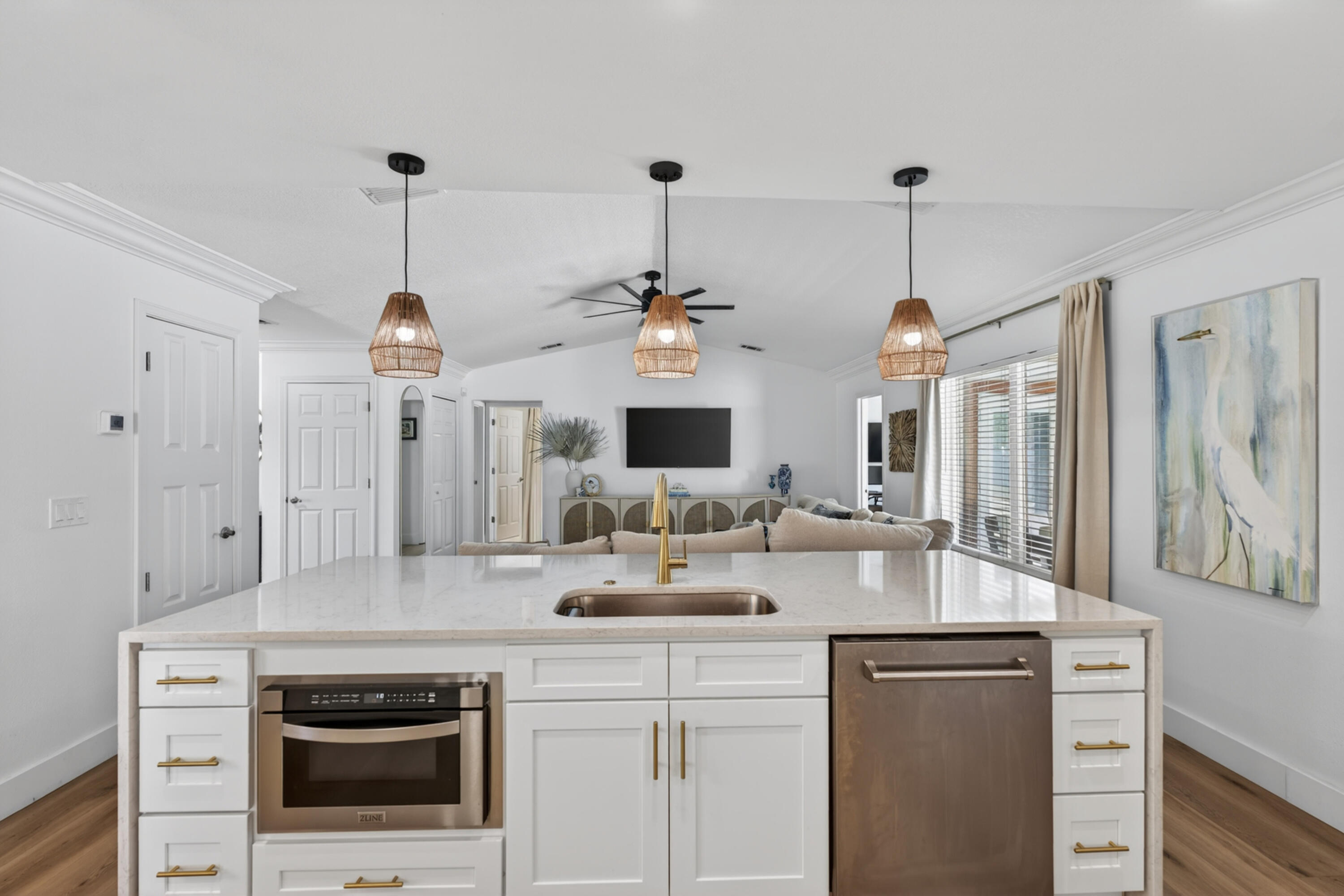 209 Santa Barbara Avenue Santa Rosa Beach, FL 32459 - Photo 15 of 78 a kitchen with kitchen island granite countertop a sink cabinets and wooden floor