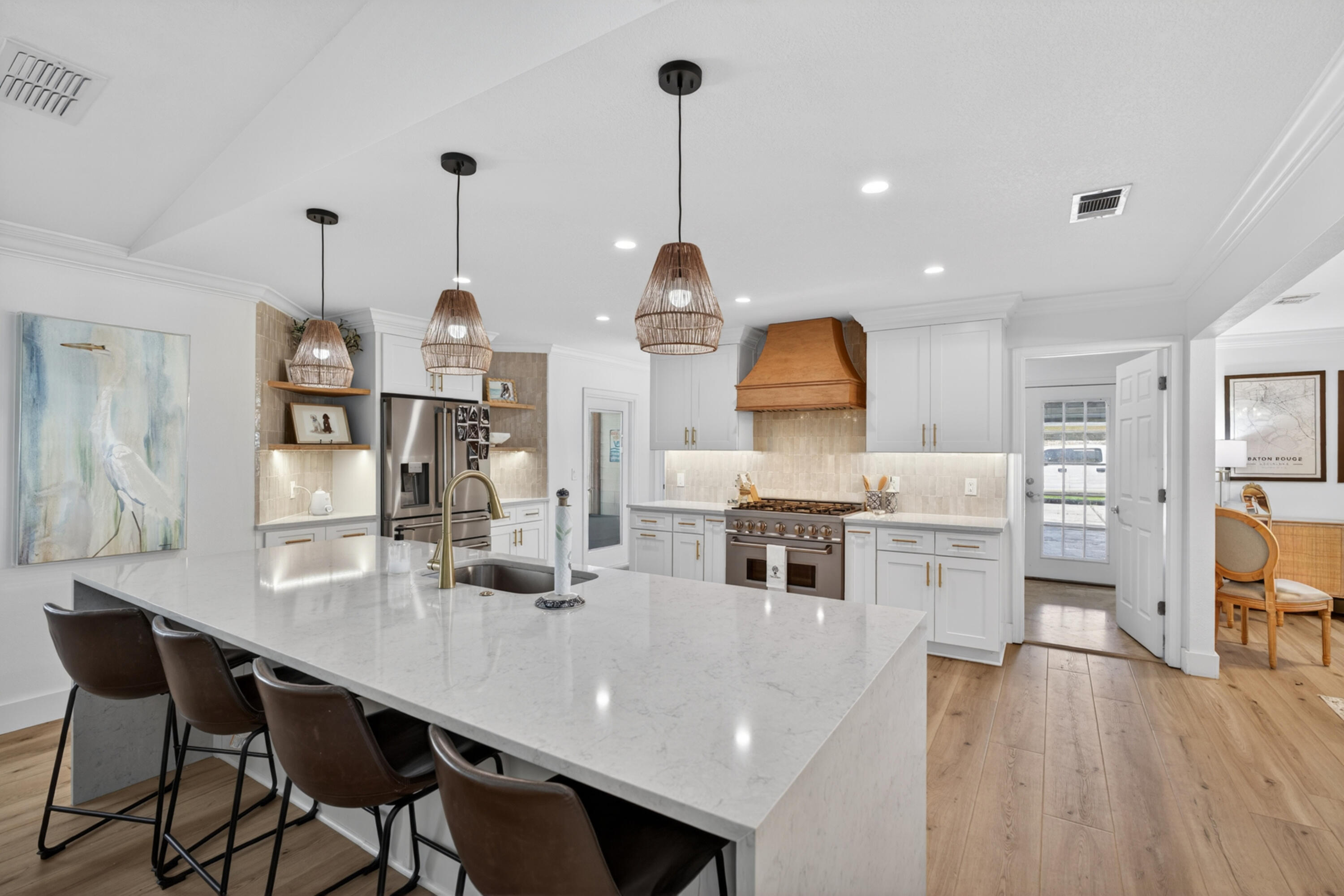 209 Santa Barbara Avenue Santa Rosa Beach, FL 32459 - Photo 16 of 78 a kitchen with stainless steel appliances kitchen island granite countertop a stove a sink a dining table and chairs with wooden floor