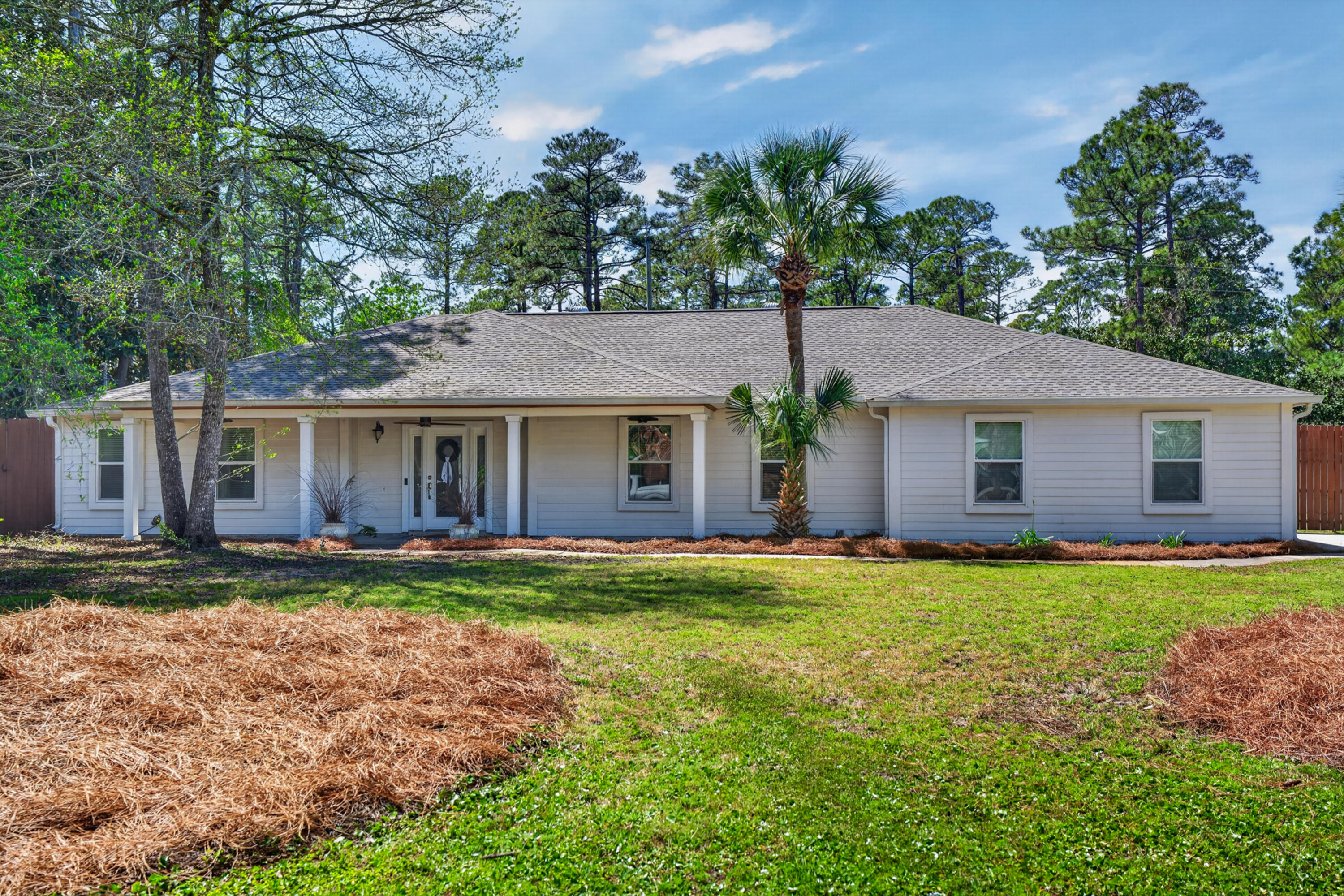 209 Santa Barbara Avenue Santa Rosa Beach, FL 32459 - Photo 3 of 78 a front view of a house with a garden