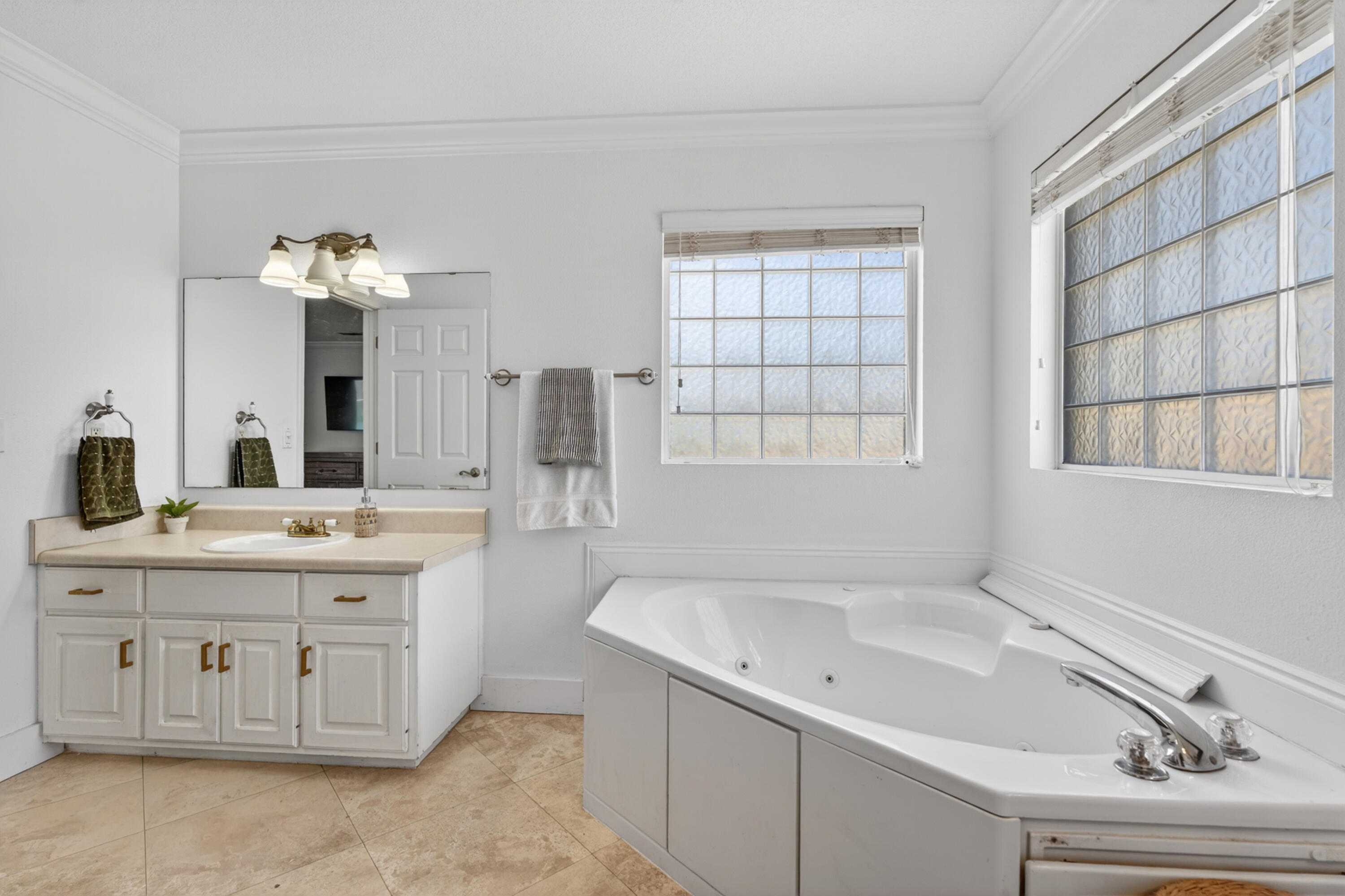 209 Santa Barbara Avenue Santa Rosa Beach, FL 32459 - Photo 38 of 78 a spacious bathroom with a granite countertop sink a large mirror and a bathtub