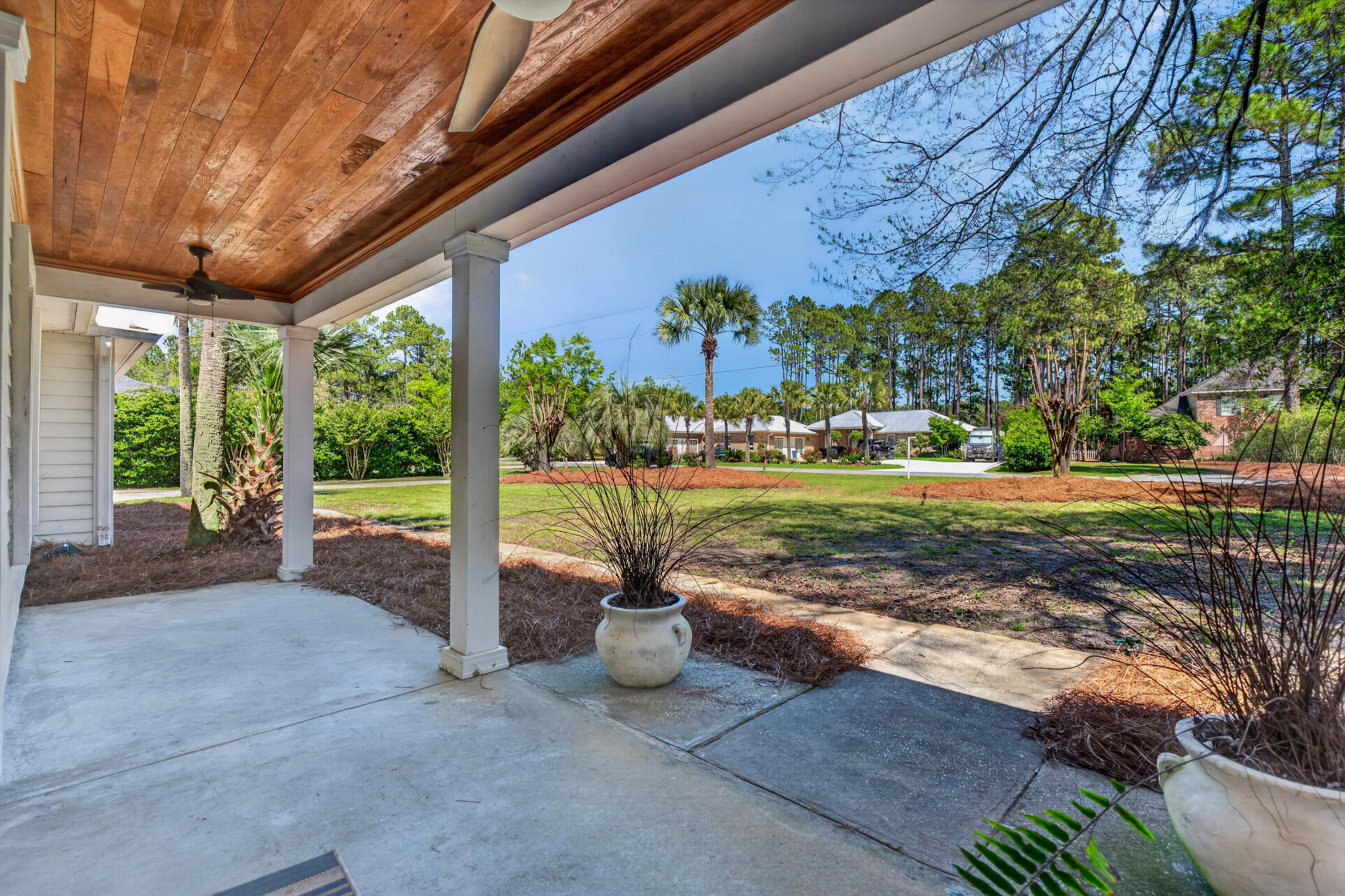 209 Santa Barbara Avenue Santa Rosa Beach, FL 32459 - Photo 58 of 78 a view of a patio with table and chairs potted plants with wooden fence