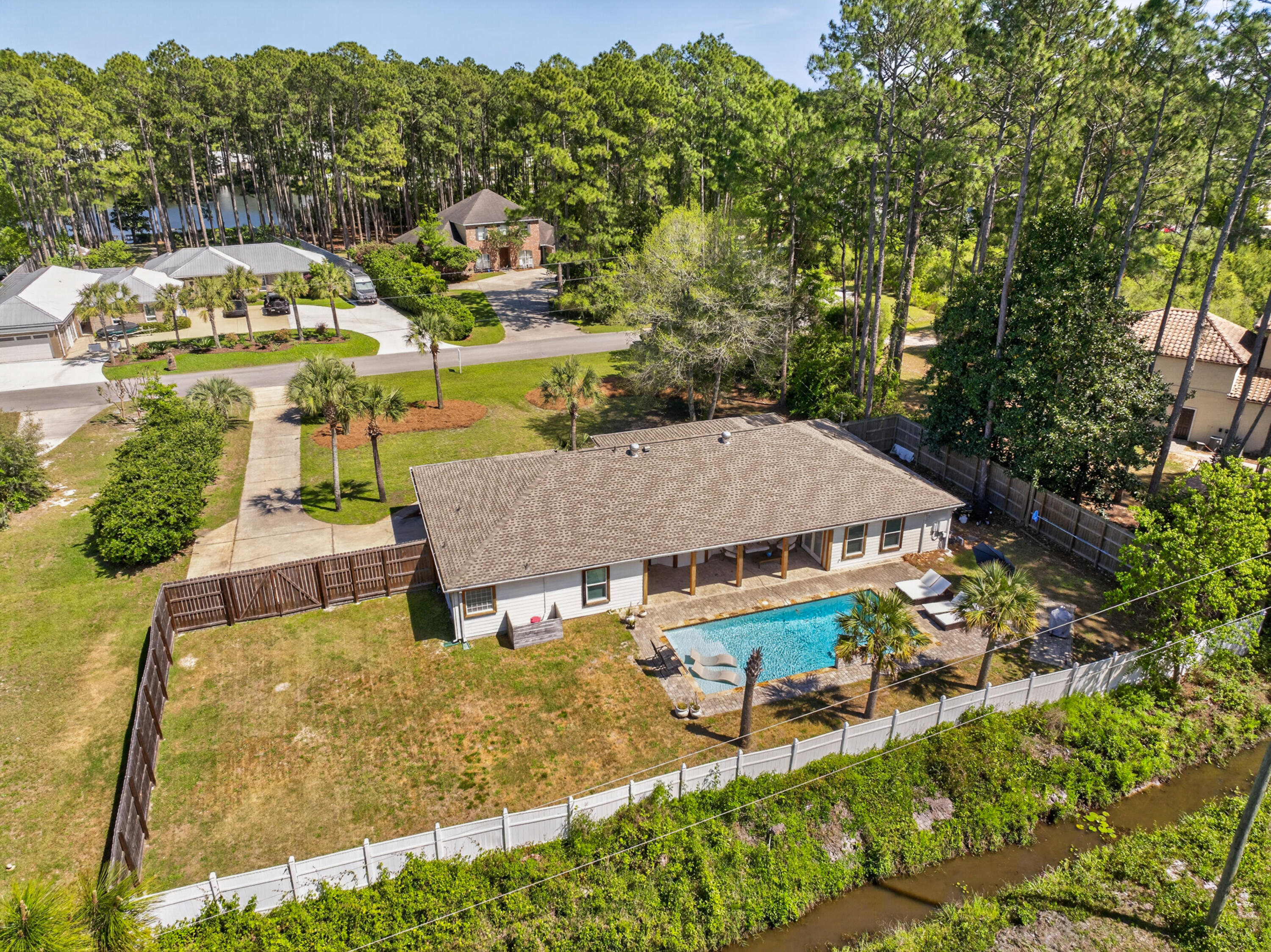 209 Santa Barbara Avenue Santa Rosa Beach, FL 32459 - Photo 64 of 78 an aerial view of a house with swimming pool and large trees