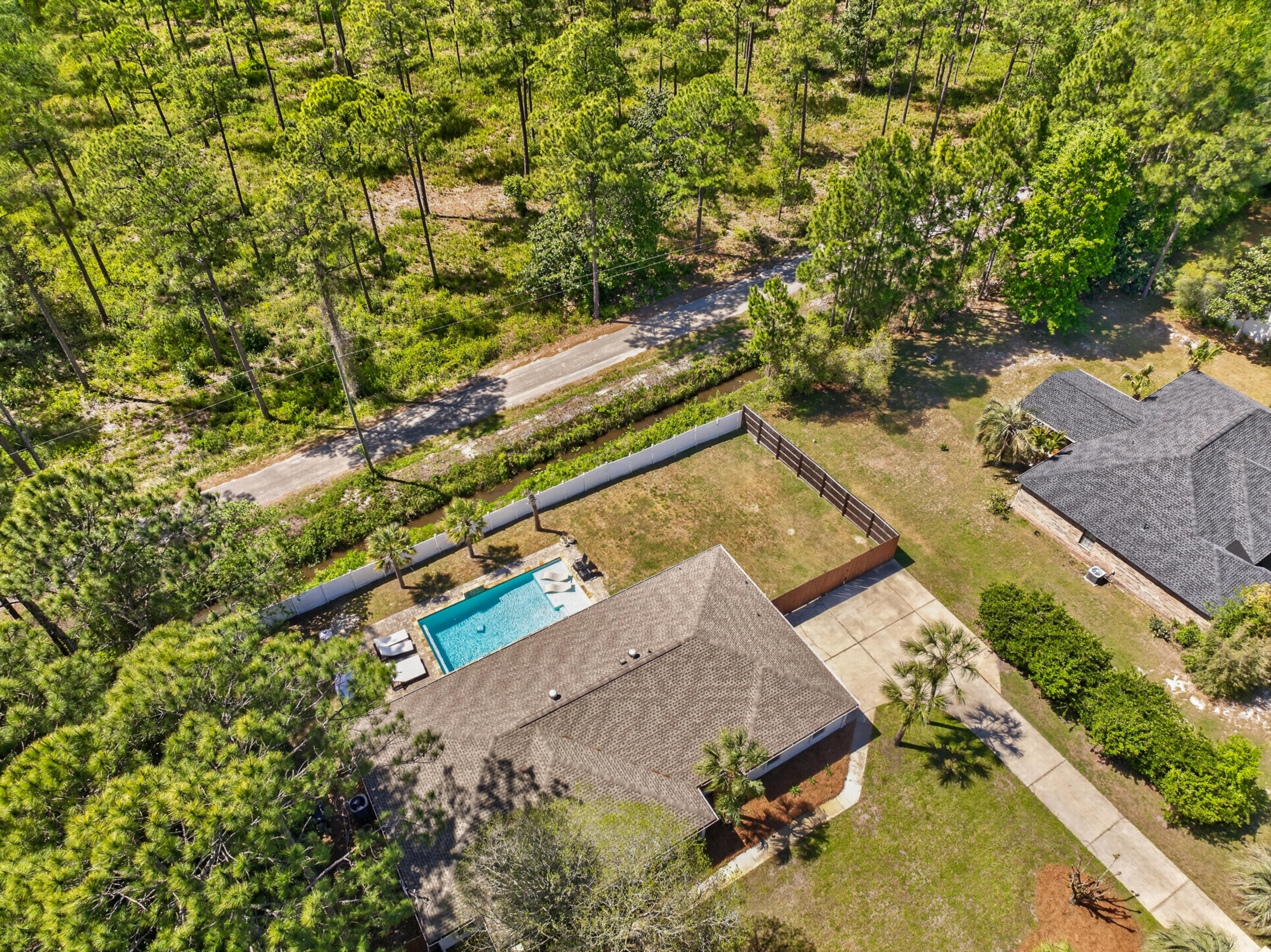 209 Santa Barbara Avenue Santa Rosa Beach, FL 32459 - Photo 72 of 78 an aerial view of a house with a yard and trees