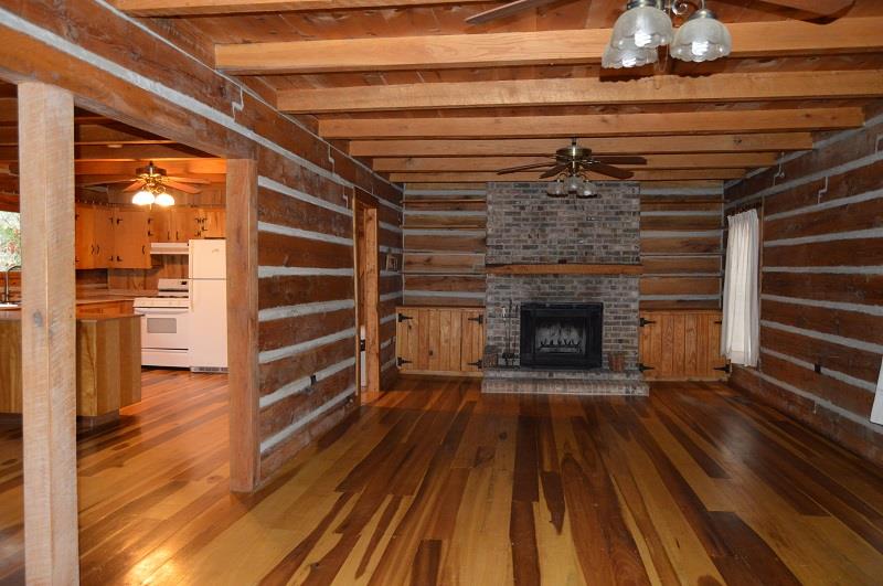 390 Ed Sanders Road Lynchburg, TN 37352 - Photo 2 of 11 a view of a livingroom with wooden floor and a fireplace