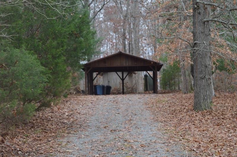 390 Ed Sanders Road Lynchburg, TN 37352 - Photo 7 of 11 a view of a wooden house with a yard and large trees