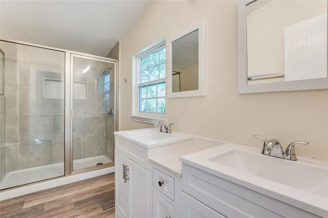 a bathroom with a sink double vanity and a mirror