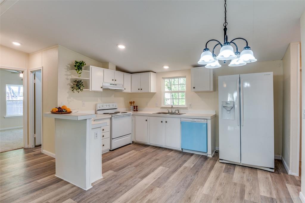 312 Oak Street Blue Ridge, TX 75424 - Photo 4 of 20 a kitchen with a refrigerator a sink cabinets and wooden floor