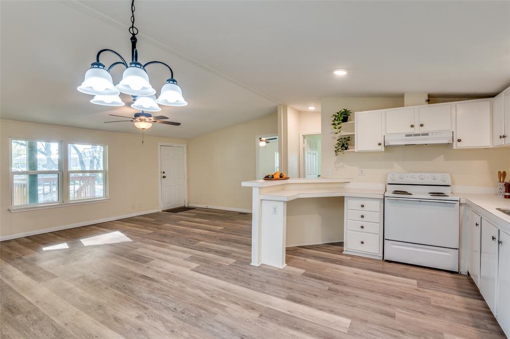 312 Oak Street Blue Ridge, TX 75424 - Photo 9 of 20 a kitchen with a white cabinets and chandelier
