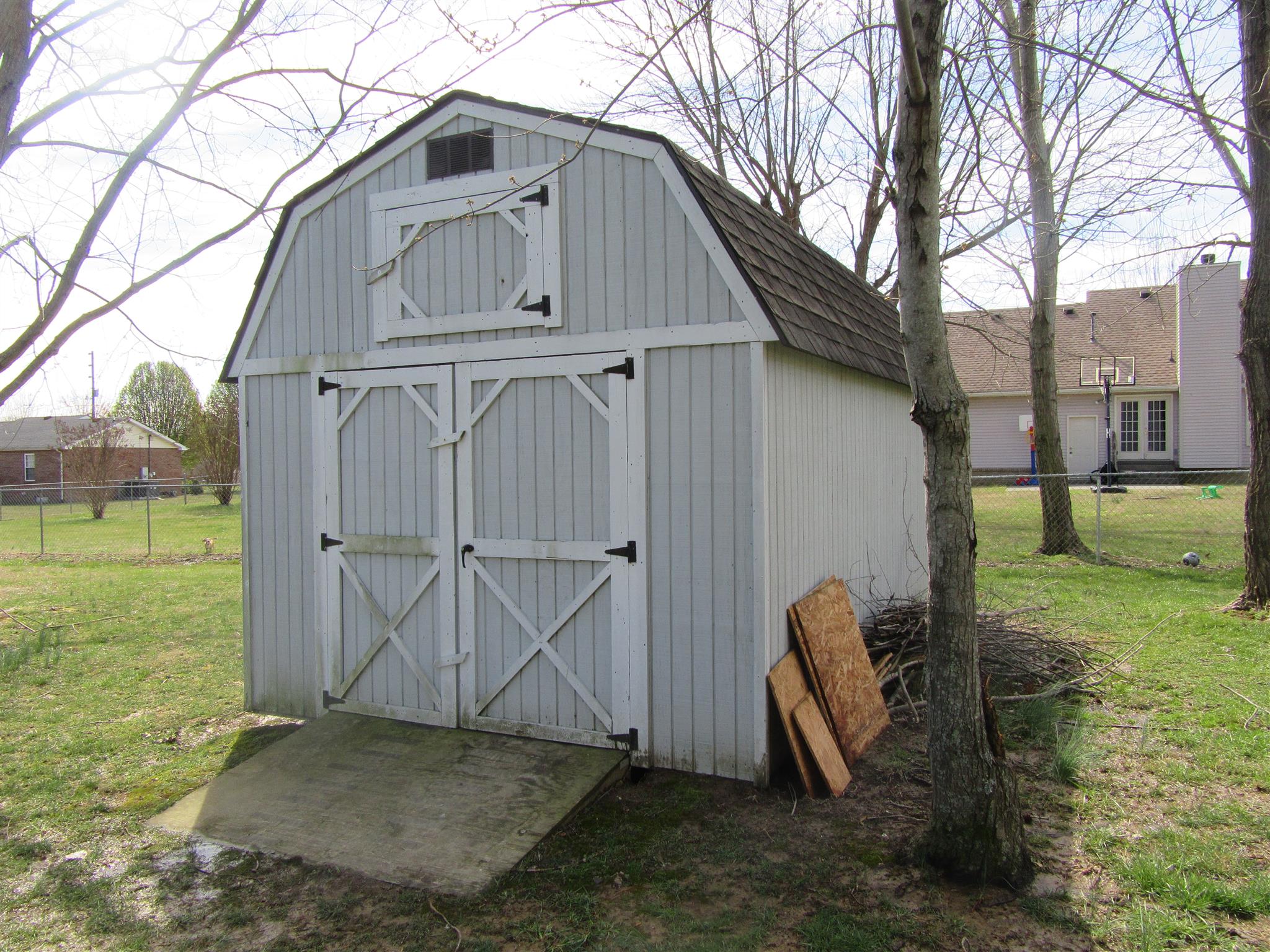 6049 Ebenezer Road Greenbrier, TN 37073 - Photo 21 of 29 a view of a wooden house with a yard and large tree