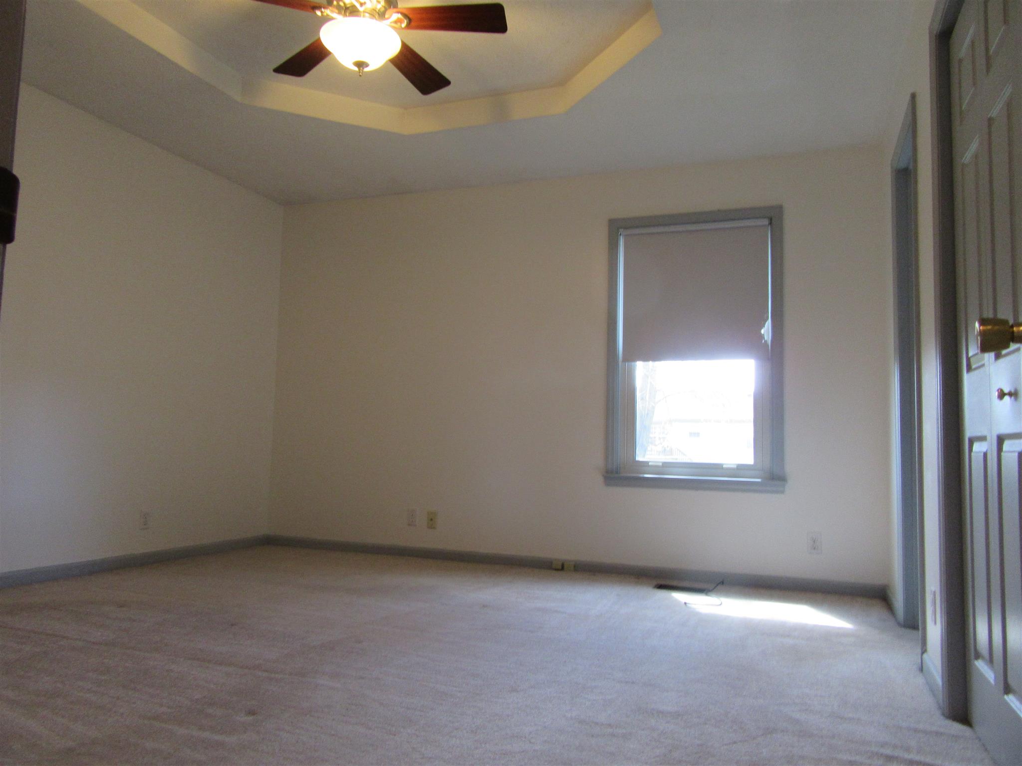 6049 Ebenezer Road Greenbrier, TN 37073 - Photo 10 of 29 an empty room with a chandelier fan and windows