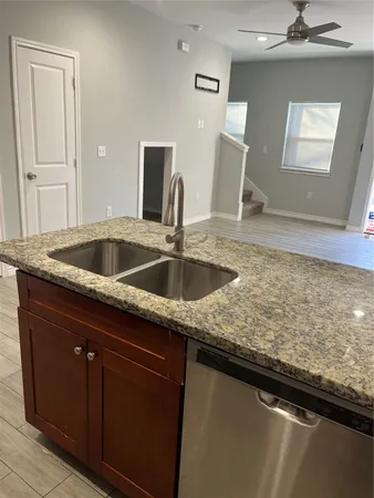 a kitchen with granite countertop a sink and a window