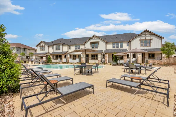 a view of a patio with couches and pool