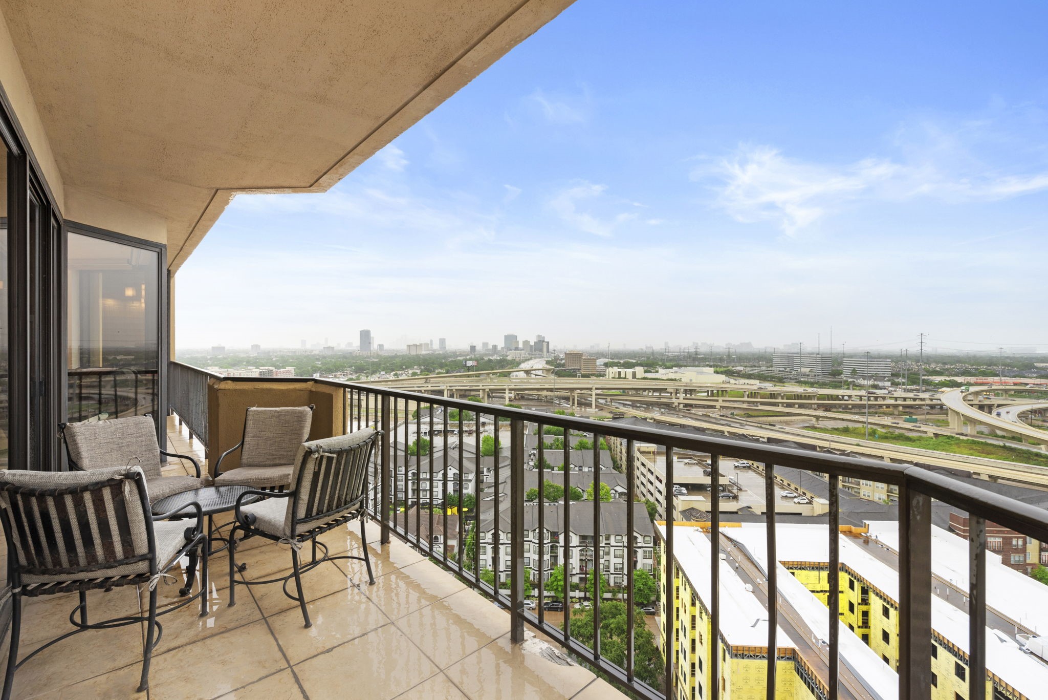 3350 McCue Road, Unit 1901 Houston, TX 77056 - Photo 19 of 29 a view of a city from a balcony with furniture