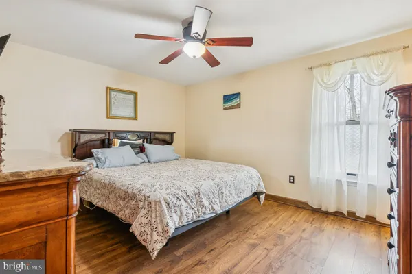 a bedroom with bed and wooden floor