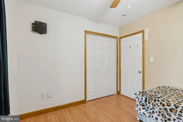 a view of a room with wooden floor and closet