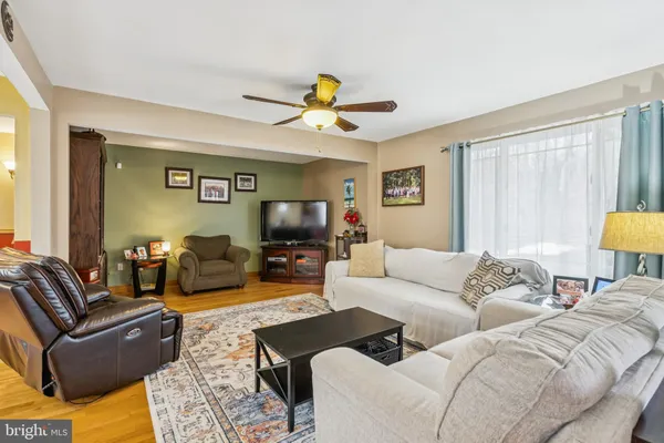 a living room with furniture a couch and a flat screen tv