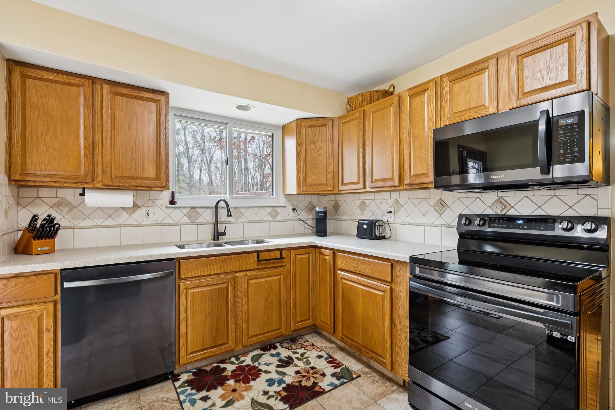 60 Spaulding Drive Monroeville, NJ 08343 - Photo 10 of 26 a kitchen with stainless steel appliances a stove sink microwave and cabinets