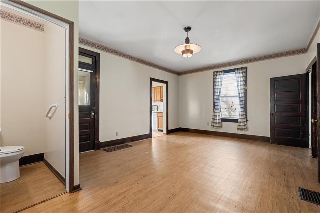 325 Walnut Street Vandergrift, PA 15690 - Photo 10 of 29 an empty room with wooden floor and windows