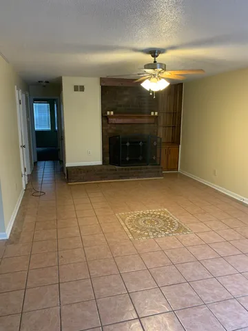 a view of a livingroom with a ceiling fan and window
