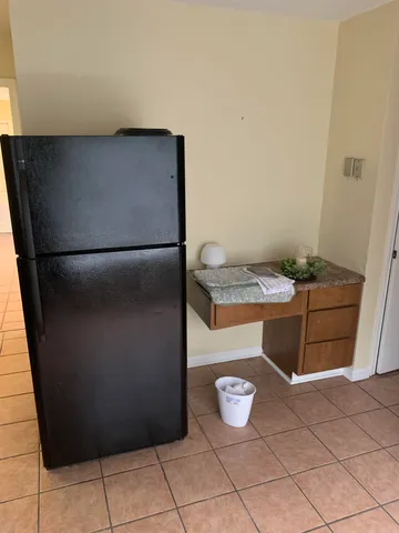 a kitchen with a refrigerator and microwave