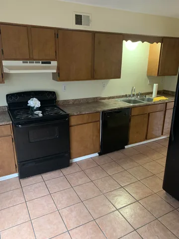 a kitchen with a sink and a stove