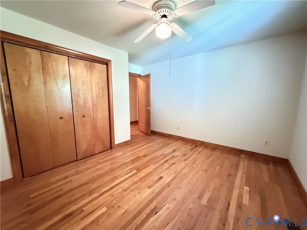 3933 Dunraven Road North Chesterfield, VA 23236 - Photo 27 of 30 an empty room with wooden floor fan and windows