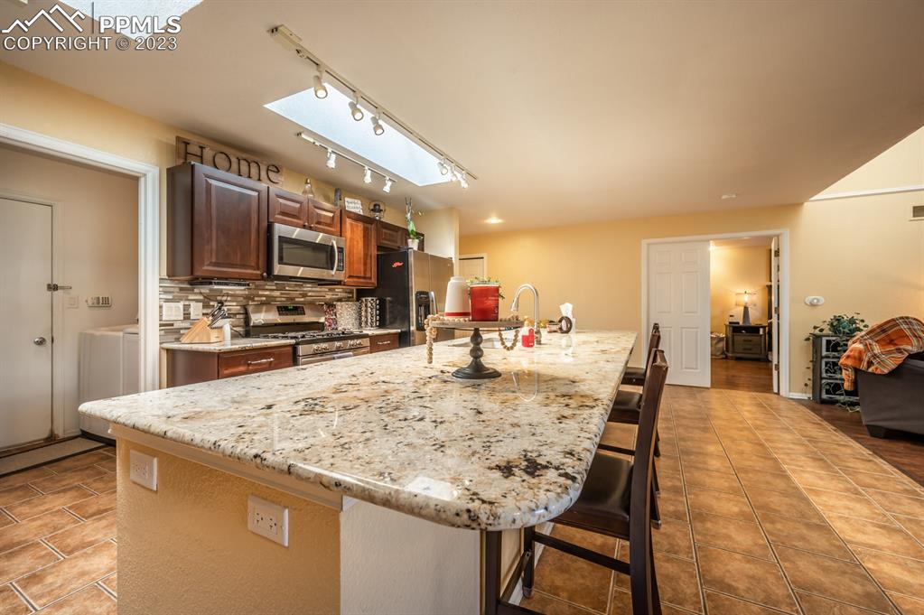 1303 Rancho Del Sol Pueblo, CO 81008 - Photo 13 of 36 a large kitchen with a table and chairs