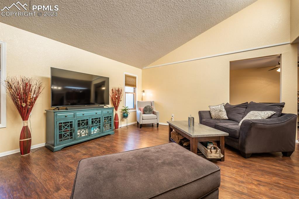 1303 Rancho Del Sol Pueblo, CO 81008 - Photo 18 of 36 a living room with furniture and a flat screen tv