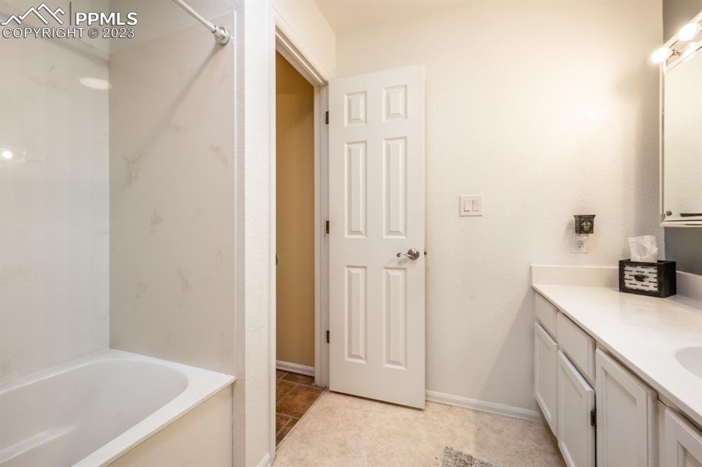 1303 Rancho Del Sol Pueblo, CO 81008 - Photo 23 of 36 a bathroom with a sink a bathtub and a shower