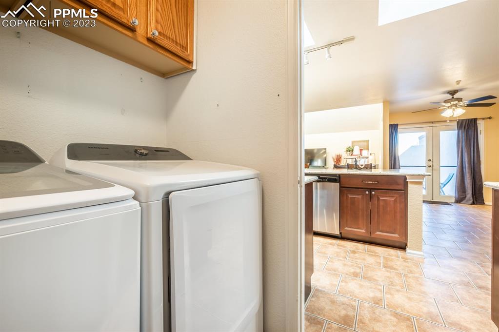 1303 Rancho Del Sol Pueblo, CO 81008 - Photo 25 of 36 a view of washer and dryer with kitchen in the background