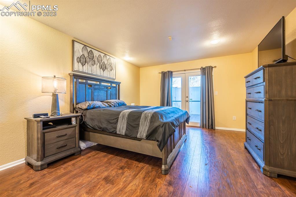 1303 Rancho Del Sol Pueblo, CO 81008 - Photo 26 of 36 a bedroom with a bed and a flat tv screen on dresser