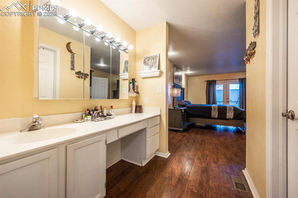 1303 Rancho Del Sol Pueblo, CO 81008 - Photo 29 of 36 a en suite bathroom with a sink double vanity granite and a mirror