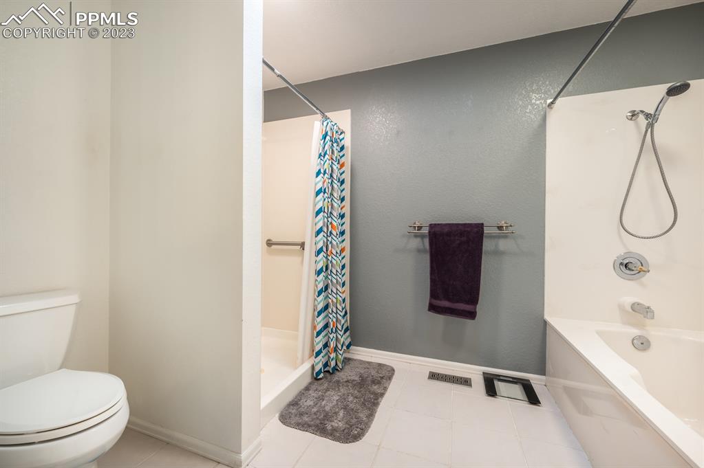 1303 Rancho Del Sol Pueblo, CO 81008 - Photo 30 of 36 a bathroom with a toilet and a shower