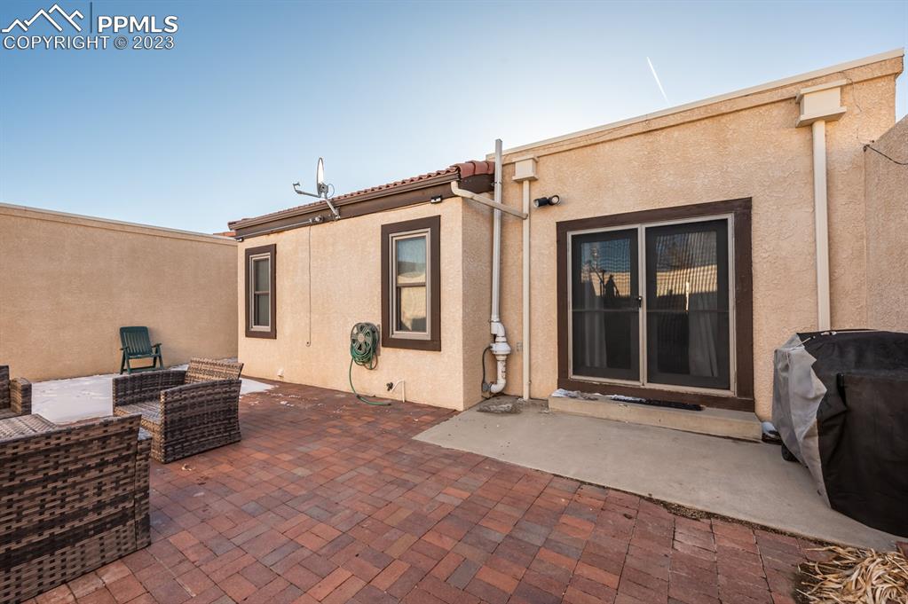 1303 Rancho Del Sol Pueblo, CO 81008 - Photo 35 of 36 a view of a house with a barbeque and wooden floor