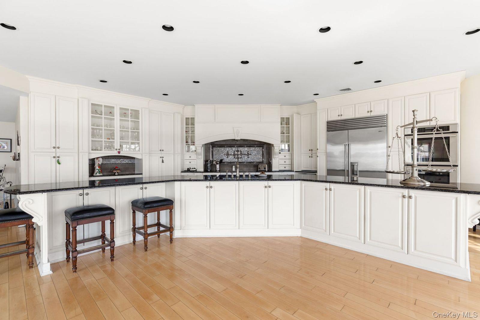 33 Beach Road Northport, NY 11768 - Photo 12 of 50 a kitchen with granite countertop white cabinets and white appliances