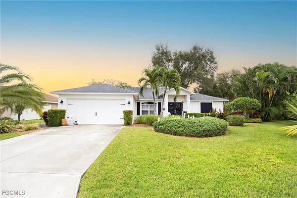 a front view of a house with a yard and garage