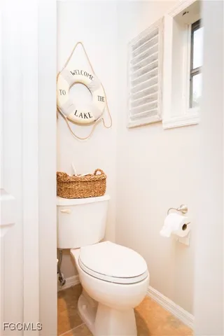 a white toilet sitting next to a bathroom sink