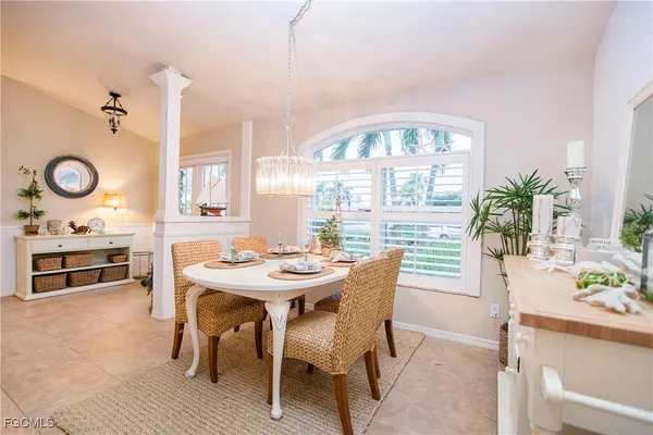 a view of a a dining room with furniture window and wooden floor