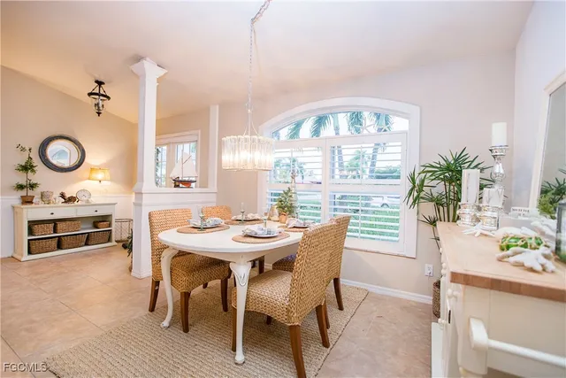 a view of a a dining room with furniture window and wooden floor