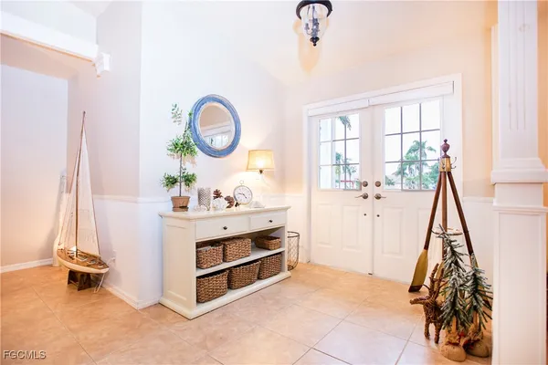 a view of a room with baby crib and a wooden floor