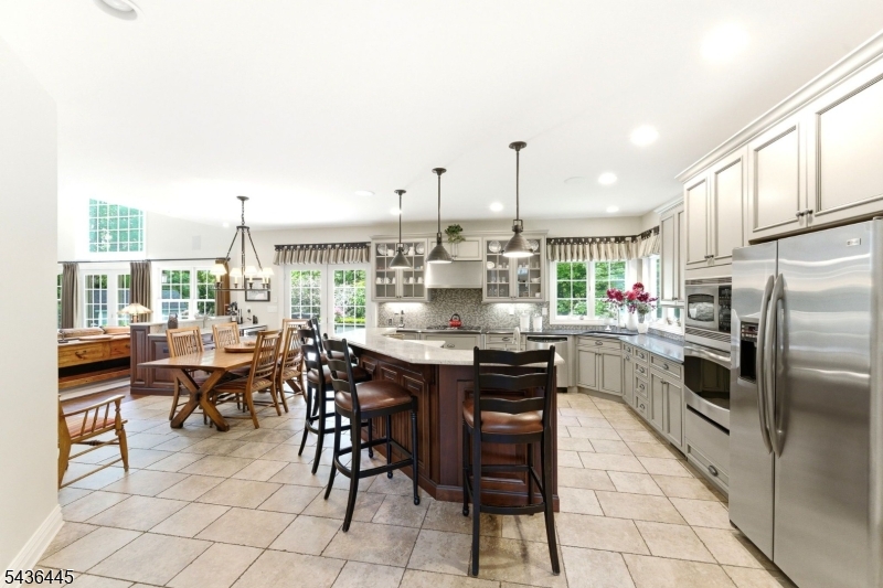 4 Windemere Way Sparta, NJ 07871 - Photo 13 of 50 a kitchen with stainless steel appliances kitchen island granite countertop a table chairs and a refrigerator