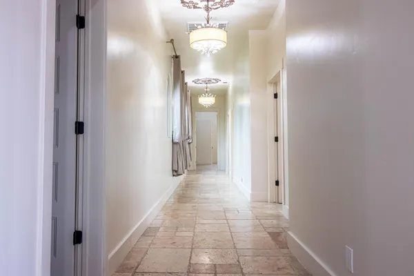 a bedroom with a large bed and a chandelier