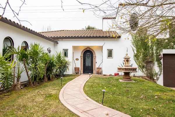 a view of a house with a yard plants and a small yard
