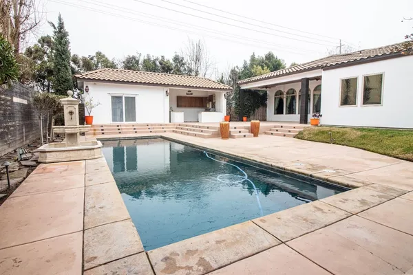 a backyard of a house with large trees