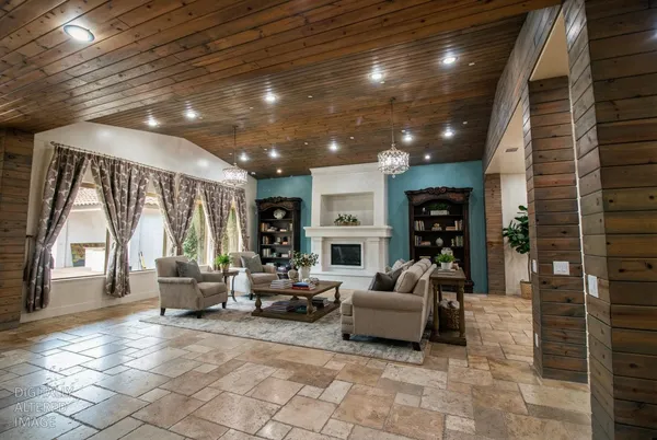 a living room with furniture large window and flat screen tv